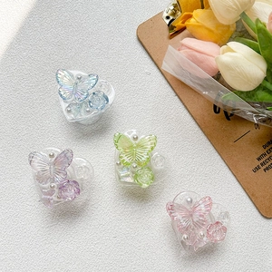 Detail of four 3D resin heart phone grips with floral rose and butterfly designs