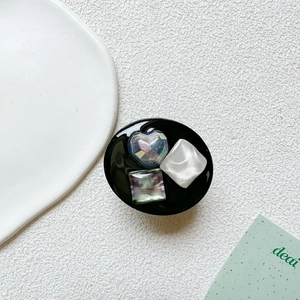 Detail of expandable phone socket with crystal heart and square gem inlays on black base