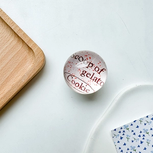 Detail of round heart phone grip with Scoop of gelato Cookie text on glass surface