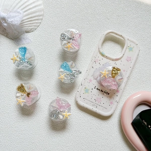 Sparkly mermaid tail and seashell phone grip sockets on star pattern phone case