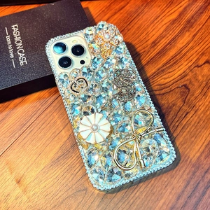 Macro shot of luxury iPhone case with 3D floral bow and crown crystal decorations