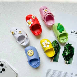 Macro view of colorful EVA foam clog charms with smiley flower and clover decorations