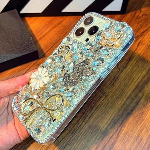 Detail of luxury iPhone case with 3D camellia, bowknot, crown and sparkling rhinestones
