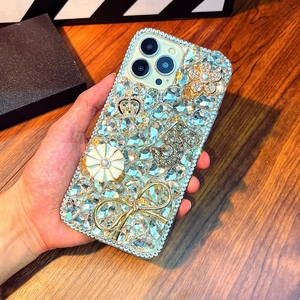 Luxury iPhone case with rhinestones, crown, camellia flower and golden bow decorations