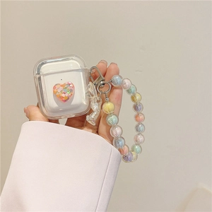 Detail view of transparent AirPods case with glitter heart and colorful beaded lanyard