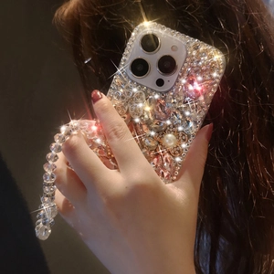 Close-up of luxury iPhone case with rhinestones, pearls, flowers and beaded wristlet