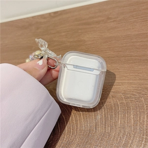 Detailed view of clear AirPods case with beaded wrist strap and translucent butterfly charm