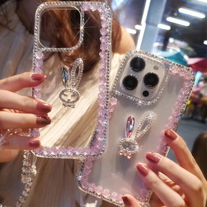 Detailed view of luxury rhinestone rabbit and floral accents on clear iPhone case