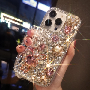 Close-up of luxury iPhone case with rhinestones, pink gems, flowers and pearls