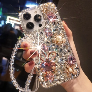 Detail of luxury iPhone case featuring pearls, pink rhinestones, and a rabbit charm with strap