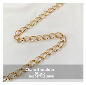 Detail shot of a glossy gold metal chain strap for trendy shoulder and bucket bags