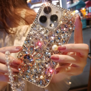 Detailed luxury iPhone case featuring encrusted crystals, pearls, and floral accents