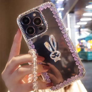 Detail of luxury rhinestone iPhone case with purple roses and a sparkling bunny charm