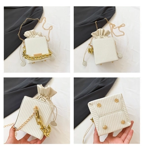 Detailed views of beige woven bucket bag with gold chain strap and protective metal feet