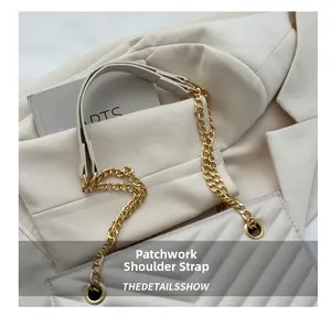 Detail of cream white quilted tote bag featuring a gold chain and leather shoulder strap
