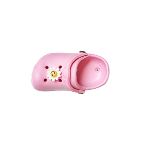 Pink EVA kids clog shoe with a smiling yellow flower charm on a white background