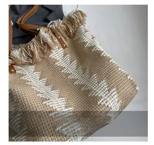 Close-up of woven triangle pattern fabric and tassel details on large tote bag