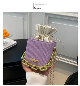 Detail of purple woven mini bucket bag with gold chain strap and drawstring inner