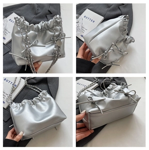 Detail view of silver pleated cloud bag with metallic bows and chain strap from four angles