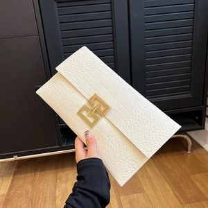 White faux leather crocodile print envelope clutch with a large gold geometric buckle