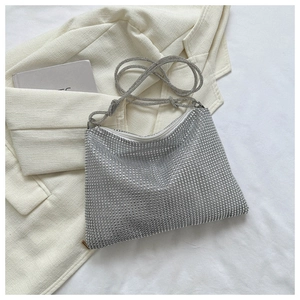 Detailed view of silver rhinestone hobo bag with knotted strap and zipper closure