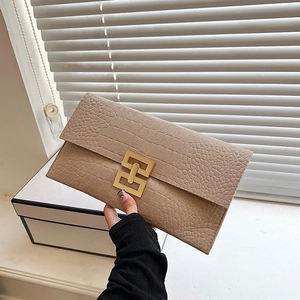 Khaki felt twill envelope clutch with crocodile texture and golden clasp on white background
