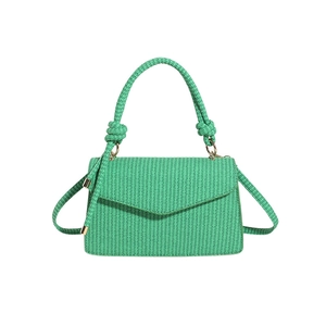 Minimalist emerald green woven handbag with a knot detail and detachable shoulder strap