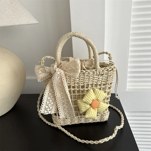 Handmade woven straw handbag with lace bow and floral accent for summer vacation