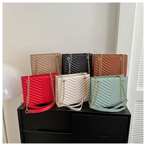 Collection of quilted leather tote bags with gold chain straps in six vibrant colors