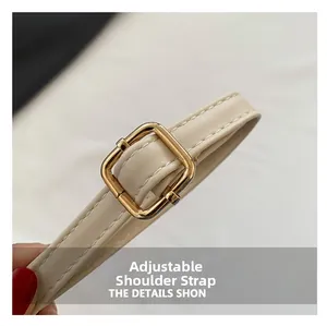 Detail of adjustable cream leather strap with gold metal buckle and neat stitching