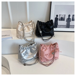 Fashionable mini bucket bags in four colors with bows and chain straps on display