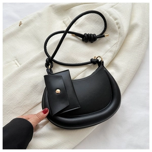 Close-up of black crescent underarm bag with small pouch and gold hardware details