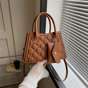 Brown quilted crossbody square bag with embossed logo and matching mini envelope pouch