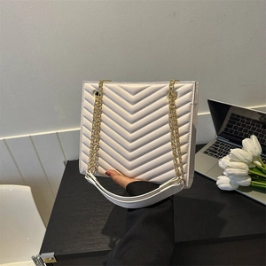 White quilted faux leather tote bag with V-pattern stitching and gold chain strap