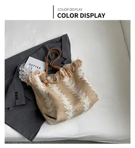 Detail of khaki woven bucket tote with fringed edges and premium leather handles