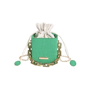 Chic green woven bucket bag with white drawstring insert and gold chain strap