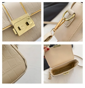 Detail showing crocodile pattern leather, gold metal lock and interior of the beige crossbody bag