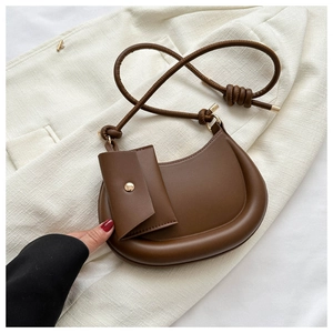 Detail of coffee brown leather hobo bag with unique knotted strap and mini pouch