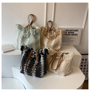 Close-up of fringe details and pine-pattern weave on multi-color handmade bucket bags