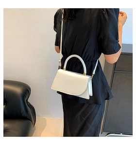 Minimalist white leather crossbody bag shown on model for stylish commute and office look