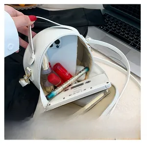 Internal view of a white PU leather round bag showing storage space for daily essentials