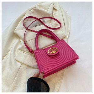 Close-up of magenta handbag featuring wave-textured leather and golden heart lock
