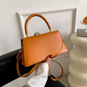 Ginger yellow handbag with round handle and adjustable shoulder strap for women