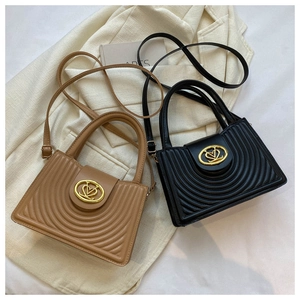 Detail of quilted square handbags with semi-circular embossing and golden buckles
