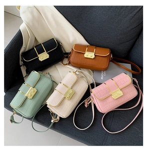 Detail of five crossbody bags featuring faux crocodile texture and gold square buckles