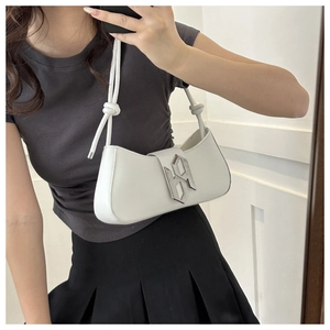 Close-up of white minimalist baguette bag featuring a silver geometric metal buckle