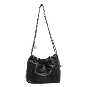 Minimalist black pleated bucket bag with bow accents and metal chain strap