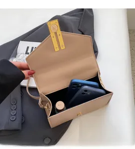 Interior capacity detail of the beige envelope crossbody bag with dual phones and perfume