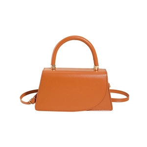 Chic camel brown trapezoid leather handbag with round handle and gold hardware detail