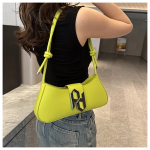 Detail of neon green shoulder bag with silver logo and unique knotted strap detail